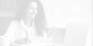A person smiling and having a friendly discussion while making notes in a notepad.